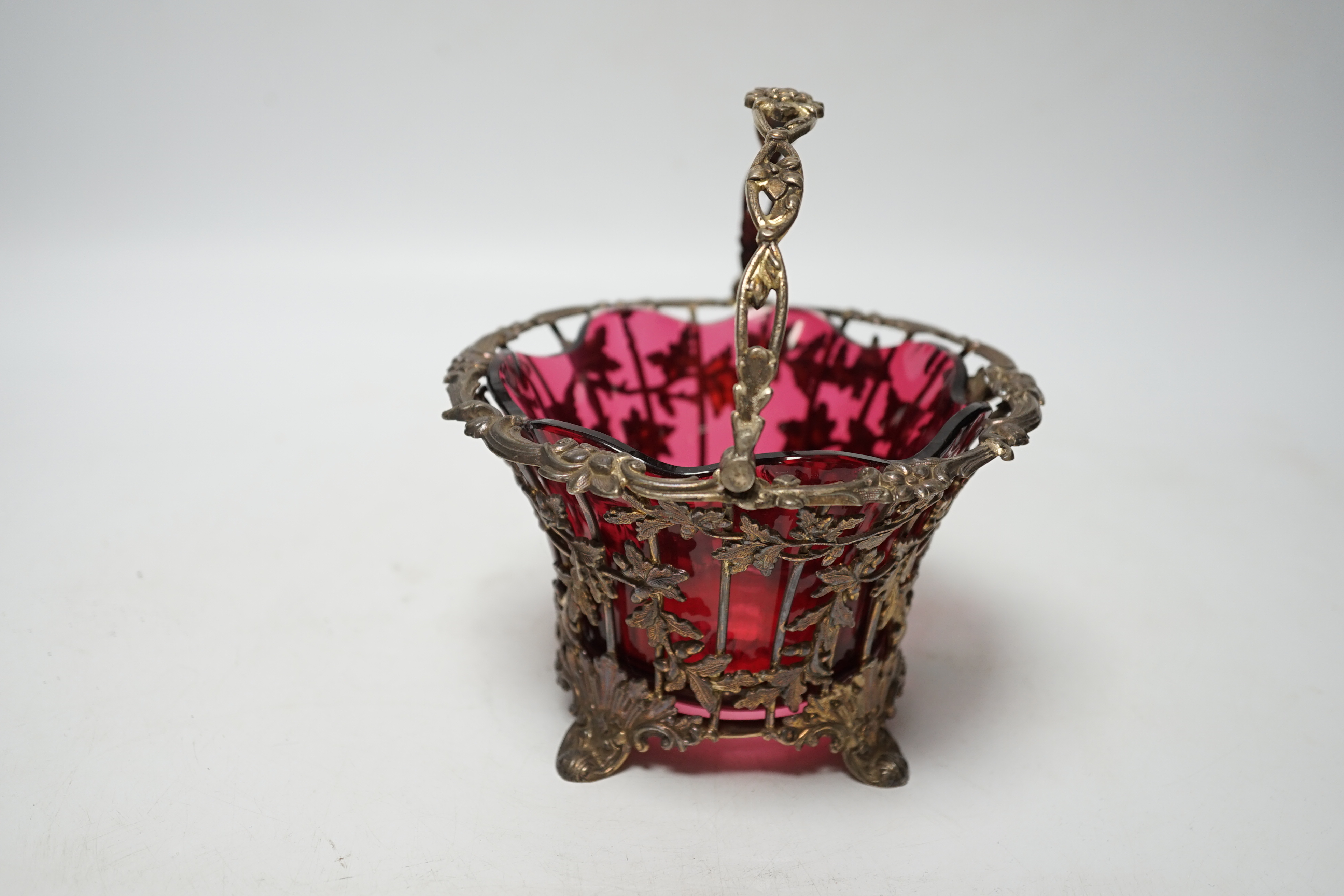 A Victorian pierced silver sugar basket, Hawksworth, Eyre & Co, Sheffield, 1842, with cranberry glass liner, diameter 13.7cm.